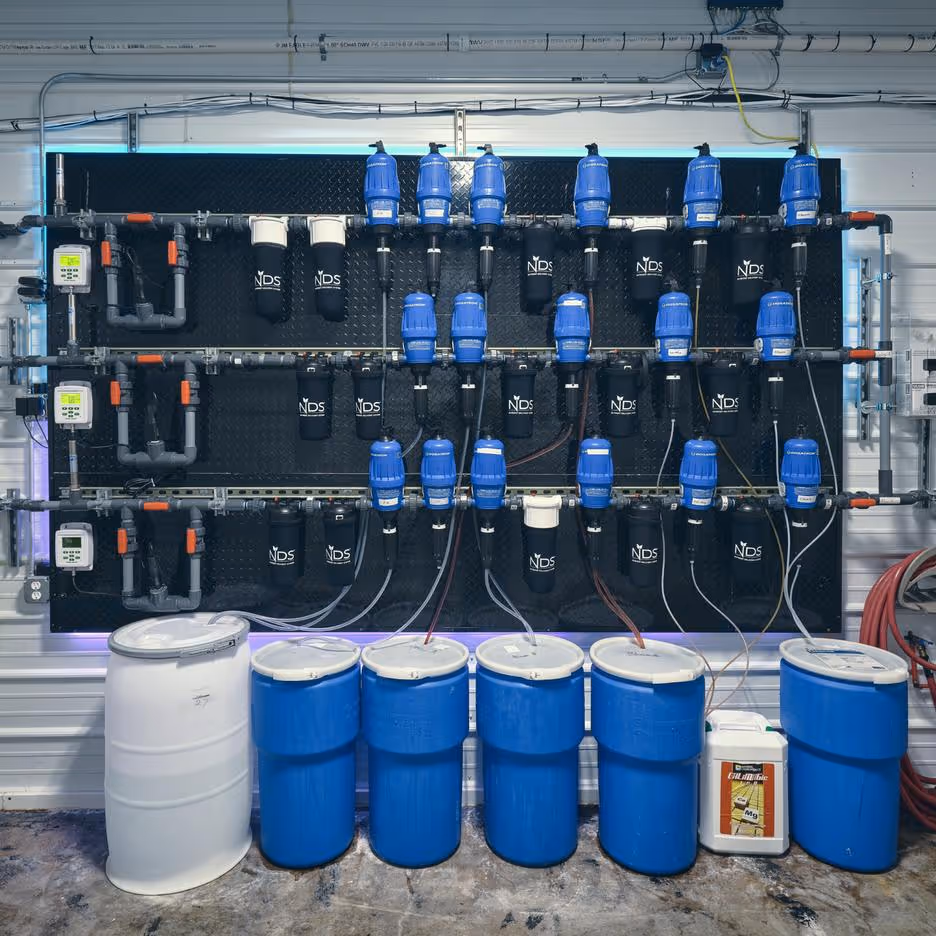 Commercial fertigation setup showing nutrient reservoirs and dosing system integrated with AROYA irrigation management