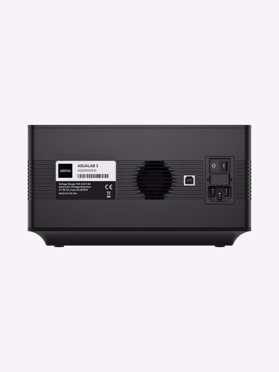 Back panel of AROYA AQUALAB 3 device with serial label, ventilation fan, and connection ports