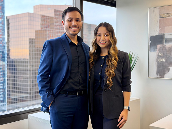 Veura CEO Catherine Kay Magsino and CXO Julius Caesar Magsino standing in an office and smiling.