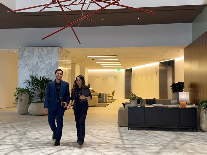 Veura CEO Catherine Kay Magsino and CXO Julius Caesar Magsino walking in the Skyline Tower lobby.