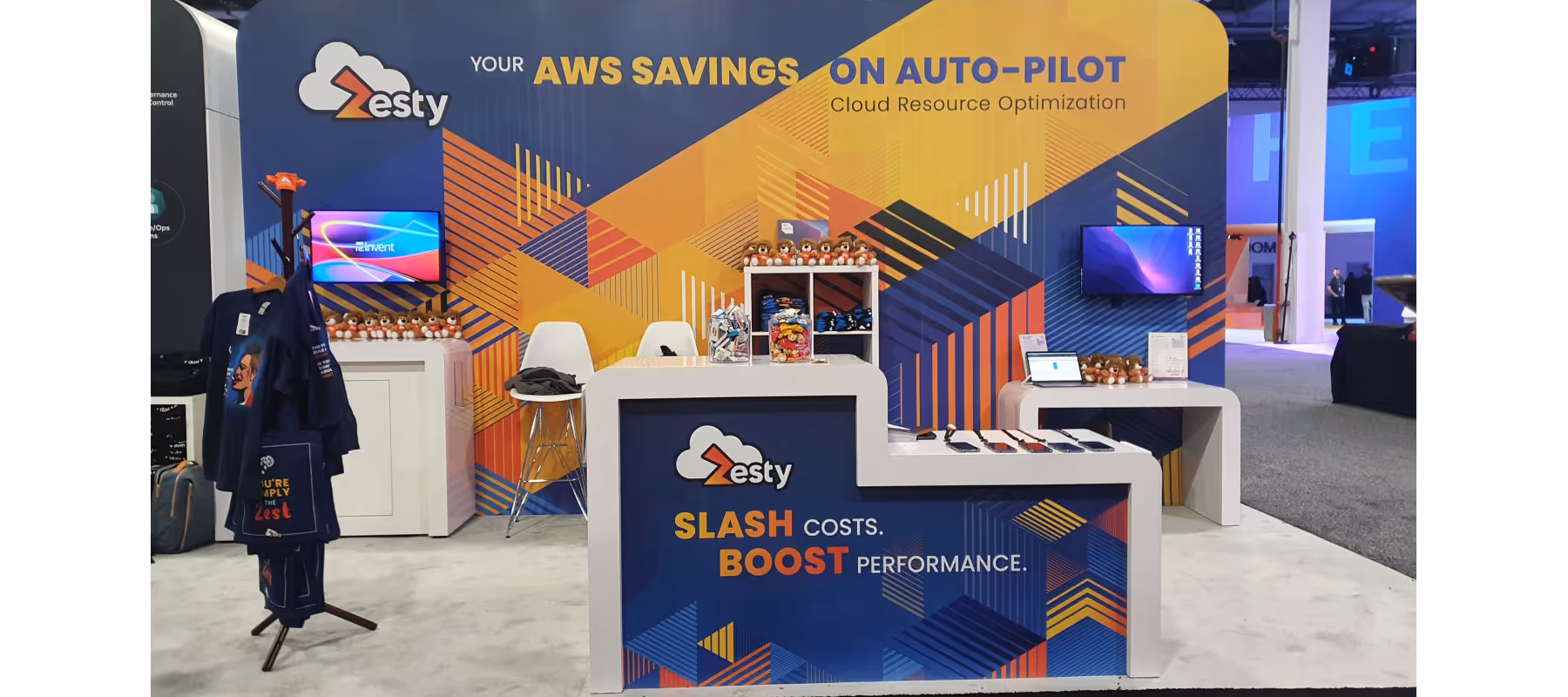 Zesty trade show booth with colorful geometric backdrop promoting AWS savings on auto-pilot.