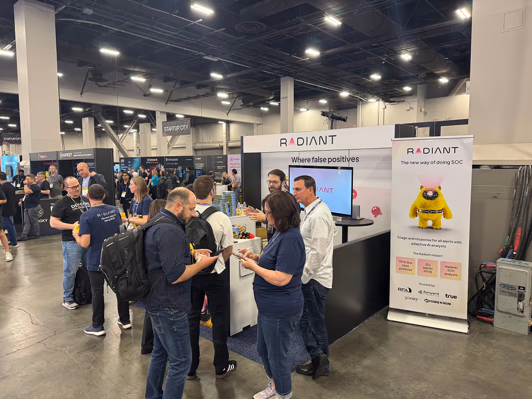 Visitors interacting with Radiant Security representatives at the company’s conference booth.