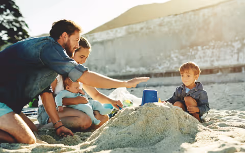 Family building sand castle