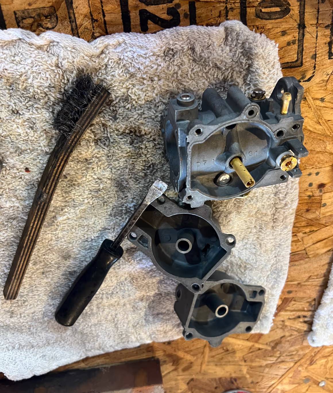 Picture of boat mechanic cleaning outboard engine carburetor. 