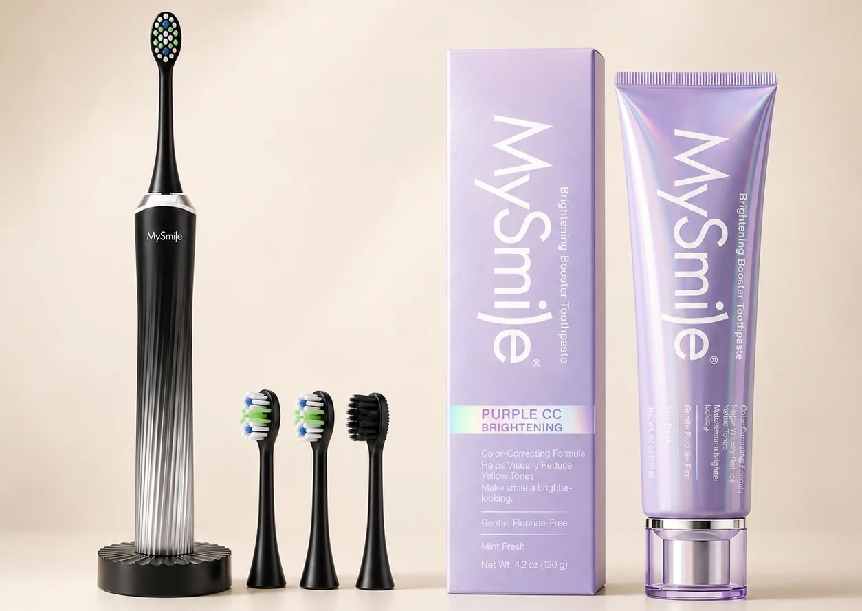 Electric toothbrush with replacement heads beside a purple brightening toothpaste tube and box