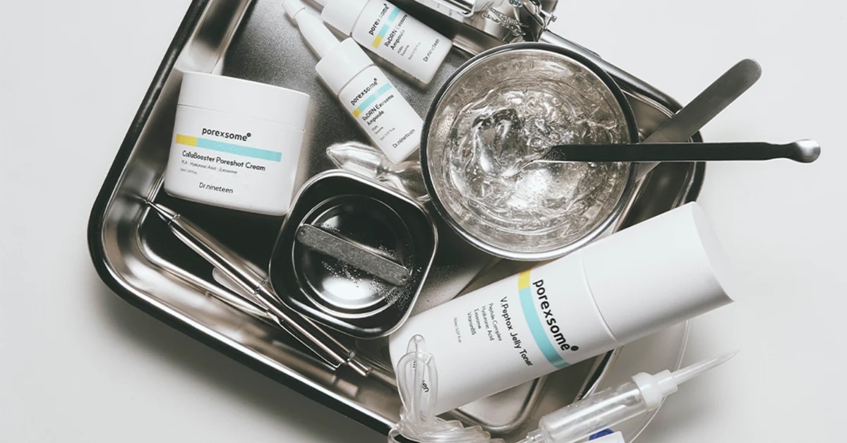 Skincare cream, ampoules and toner on a stainless steel tray with clinical tools