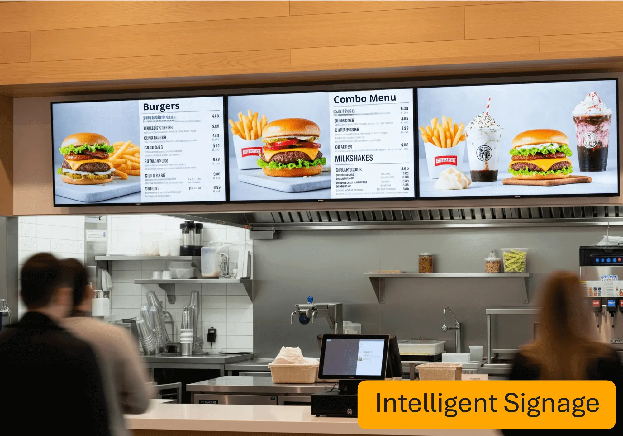 Intelligent digital signage used as Fast food menu boards showing burgers, fries, combo options, and milkshakes above a restaurant counter.