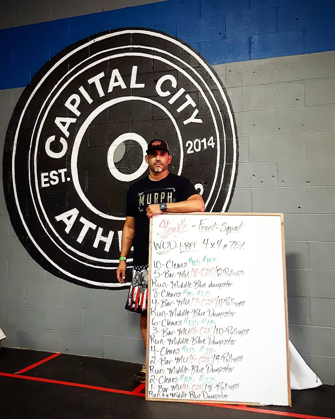 Coach with WOD (workout of the day) whiteboard at Capital City Athletics Edmonton