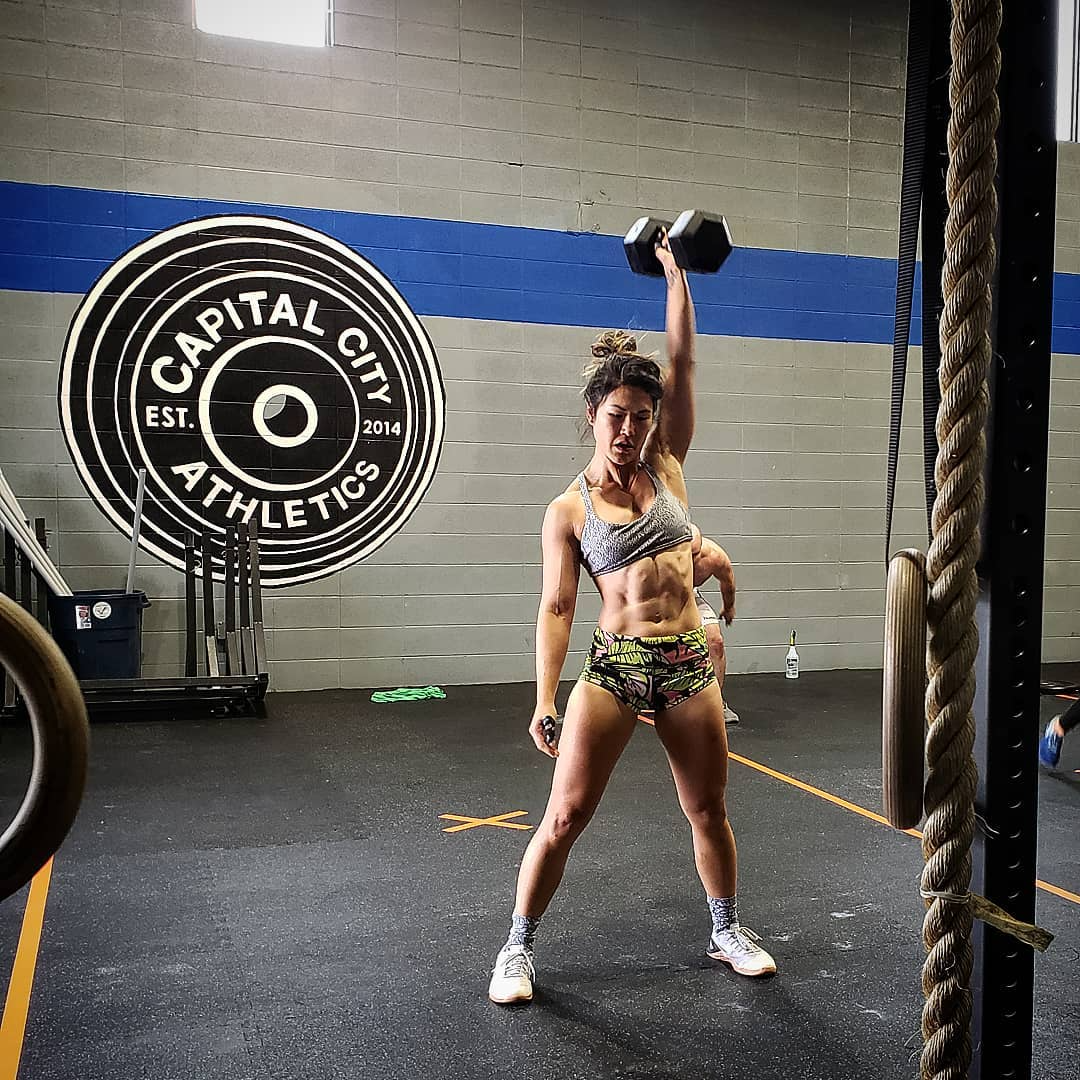 Capital City Athletics member performing a dumbbell snatch