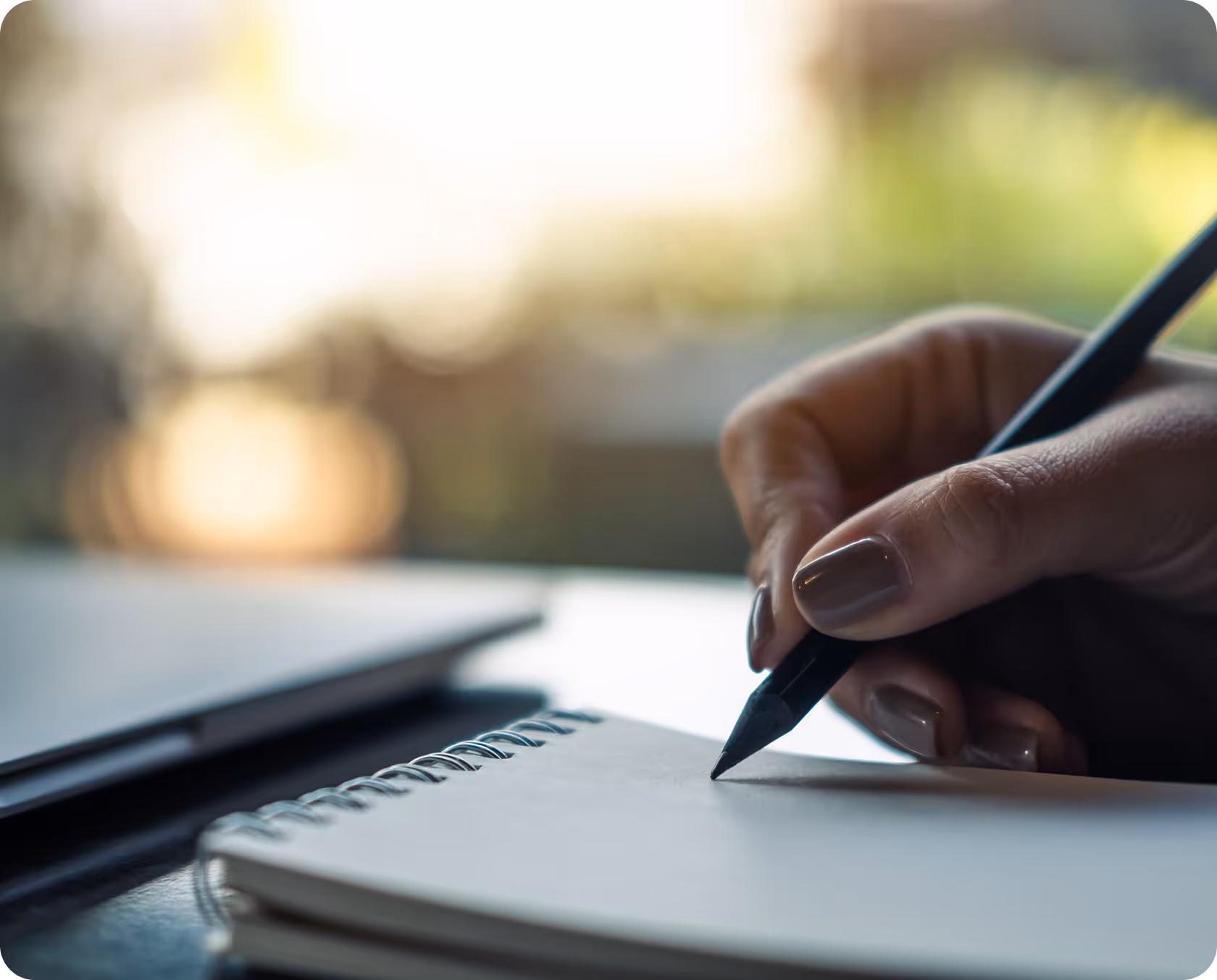 A pen writing on a notebook