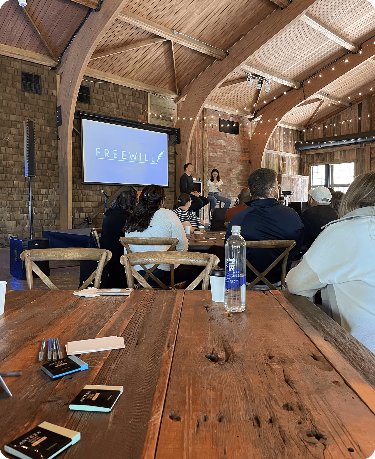 two people on stage with an audience watching