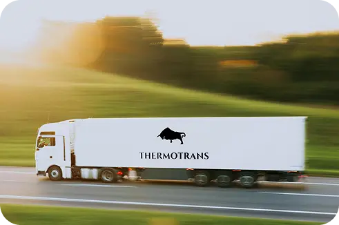 Camion Thermotrans en circulation sur la route, avec le logo visible sur la remorque