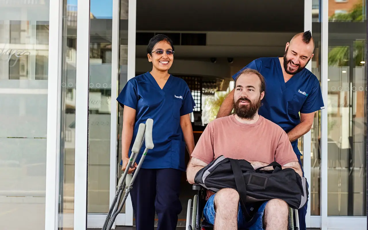 HealthX workers escorting a patient from the hospital