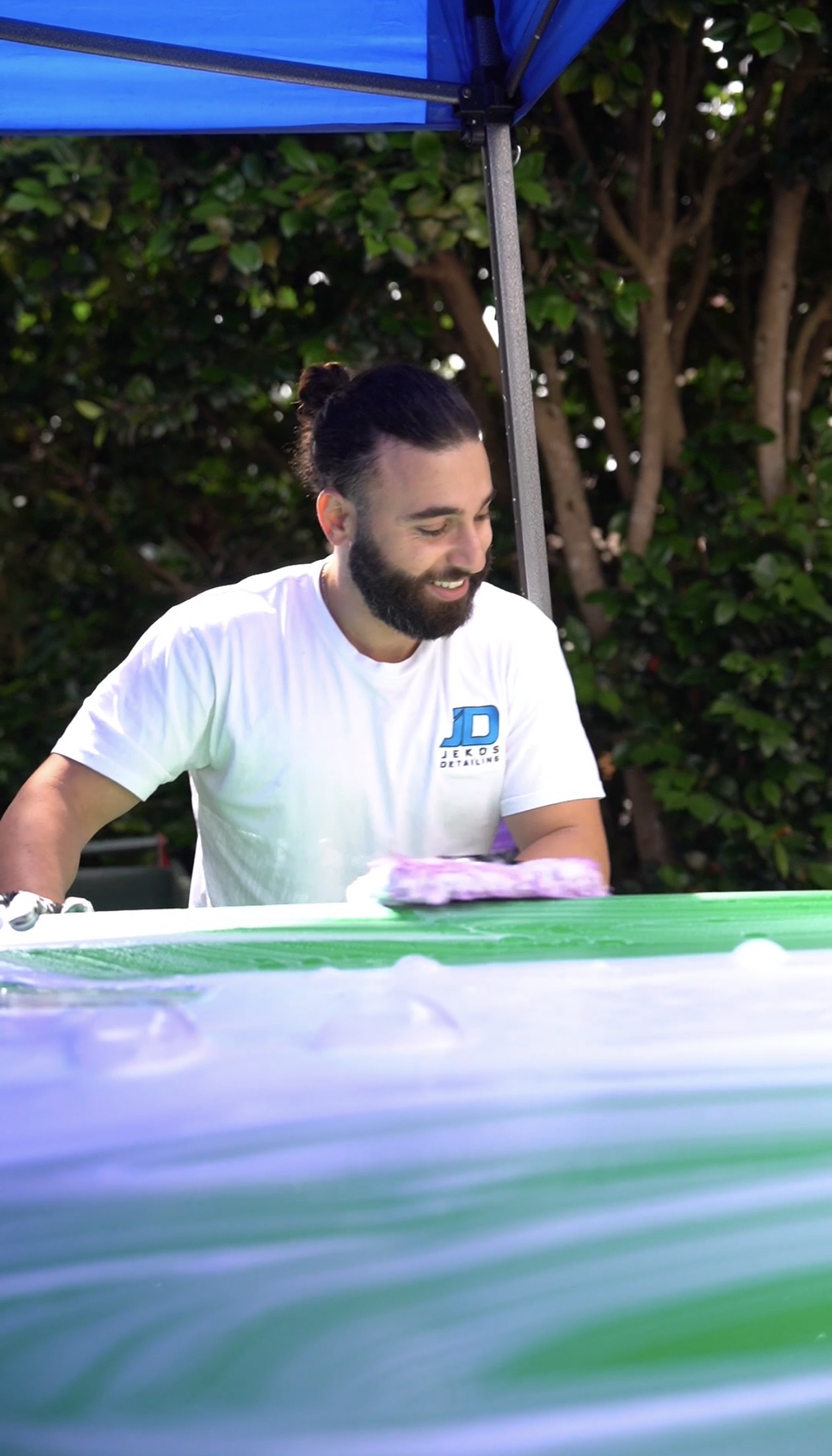 Jekos Detailing team working on a car — mobile setup in a Sydney driveway