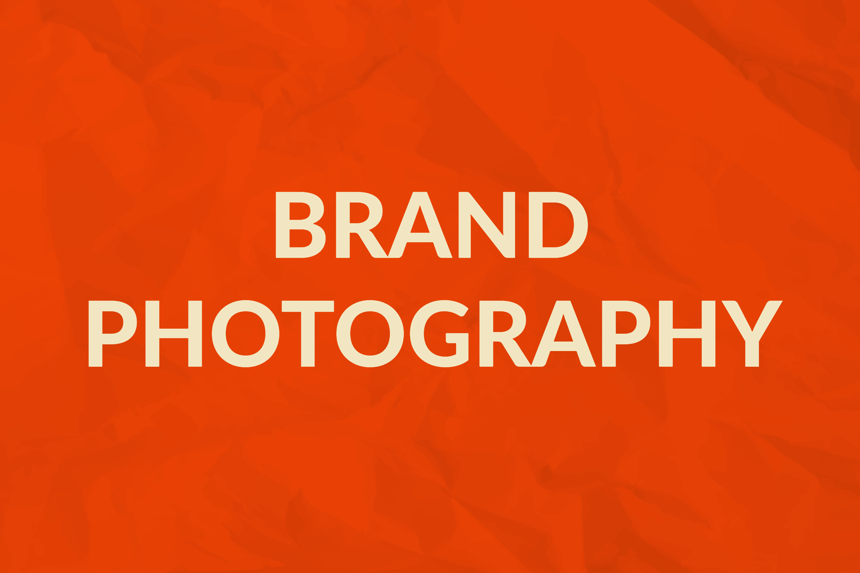 Text reading 'BRAND PHOTOGRAPHY' in bold beige letters on an orange textured background.