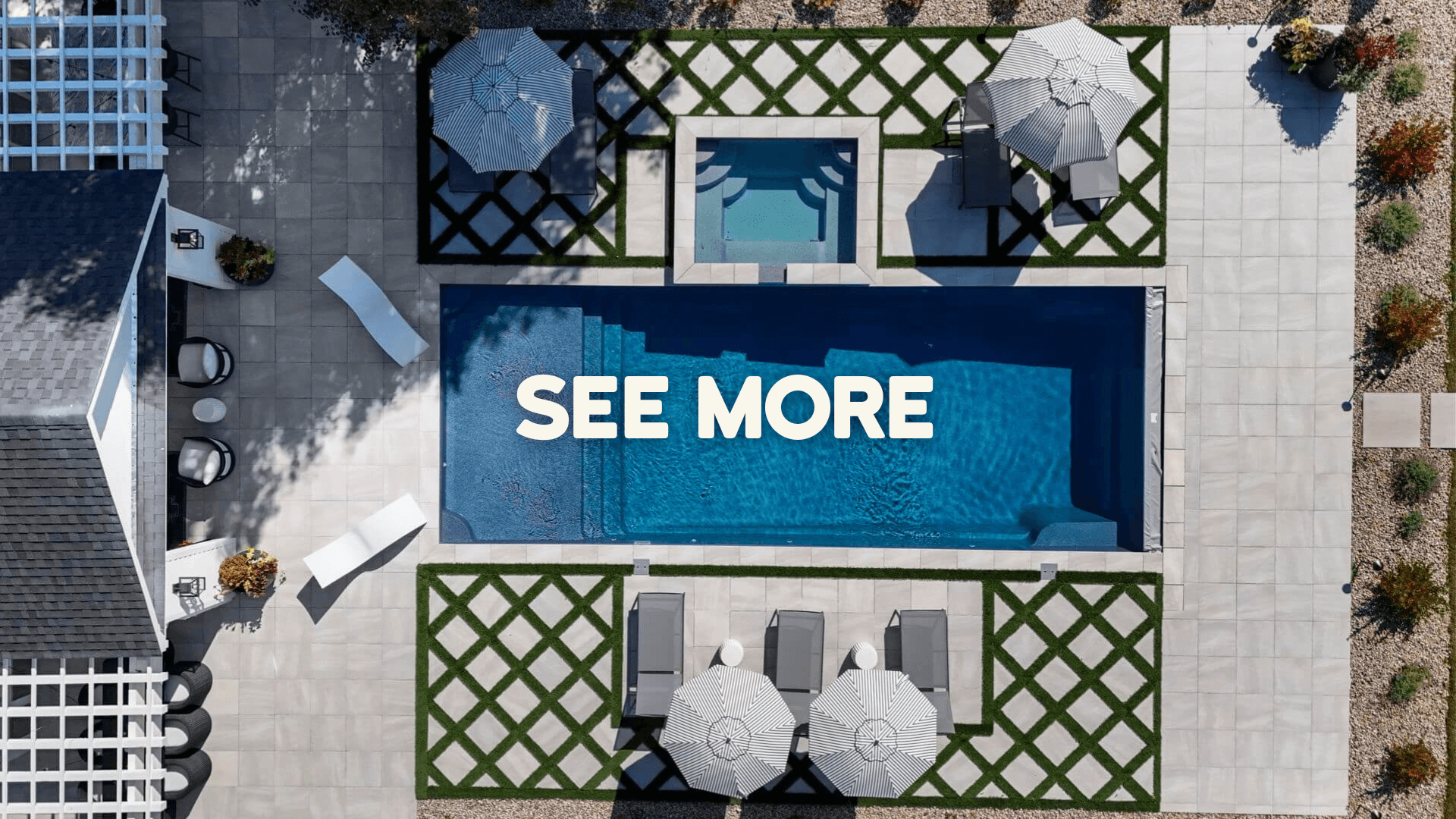 Modern dining room with a white table, eight wooden chairs, green two-tone walls, and hanging glass pendant lights.