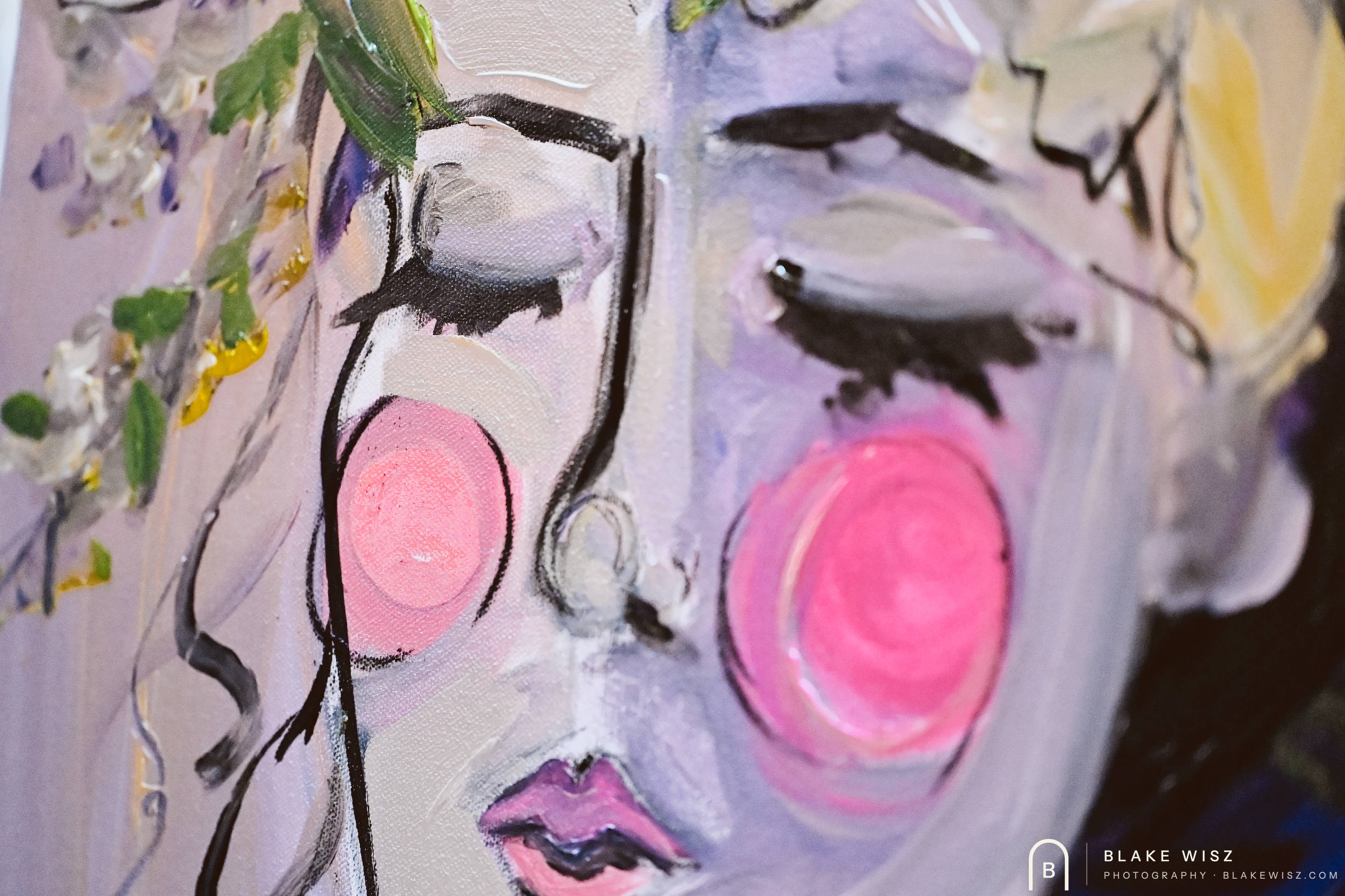 Detail of a violet painted face with pink cheeks and bold black outlines on canvas