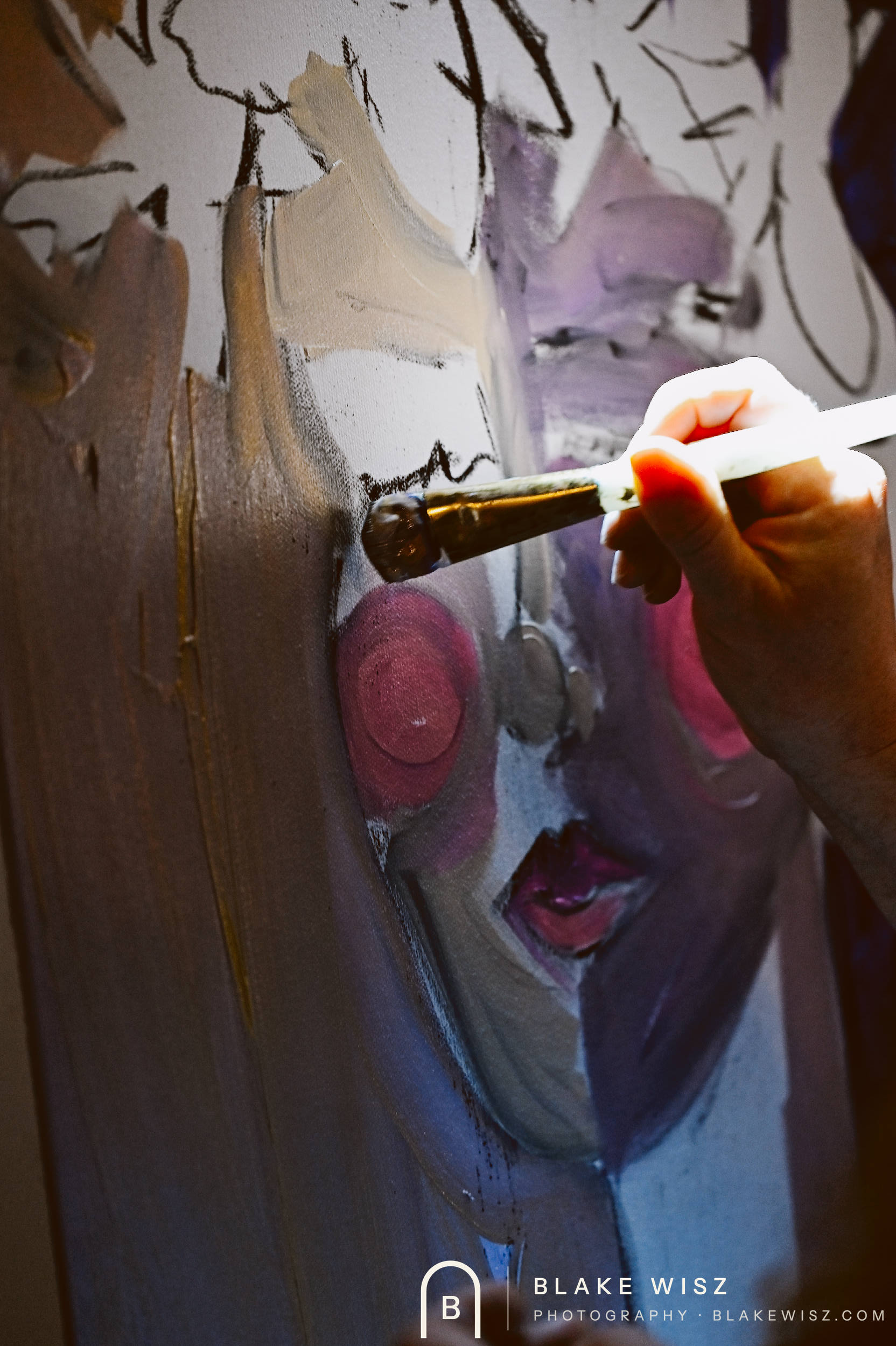 Loaded brush working the cheek of a violet portrait in progress at Art Battle Ormond Beach