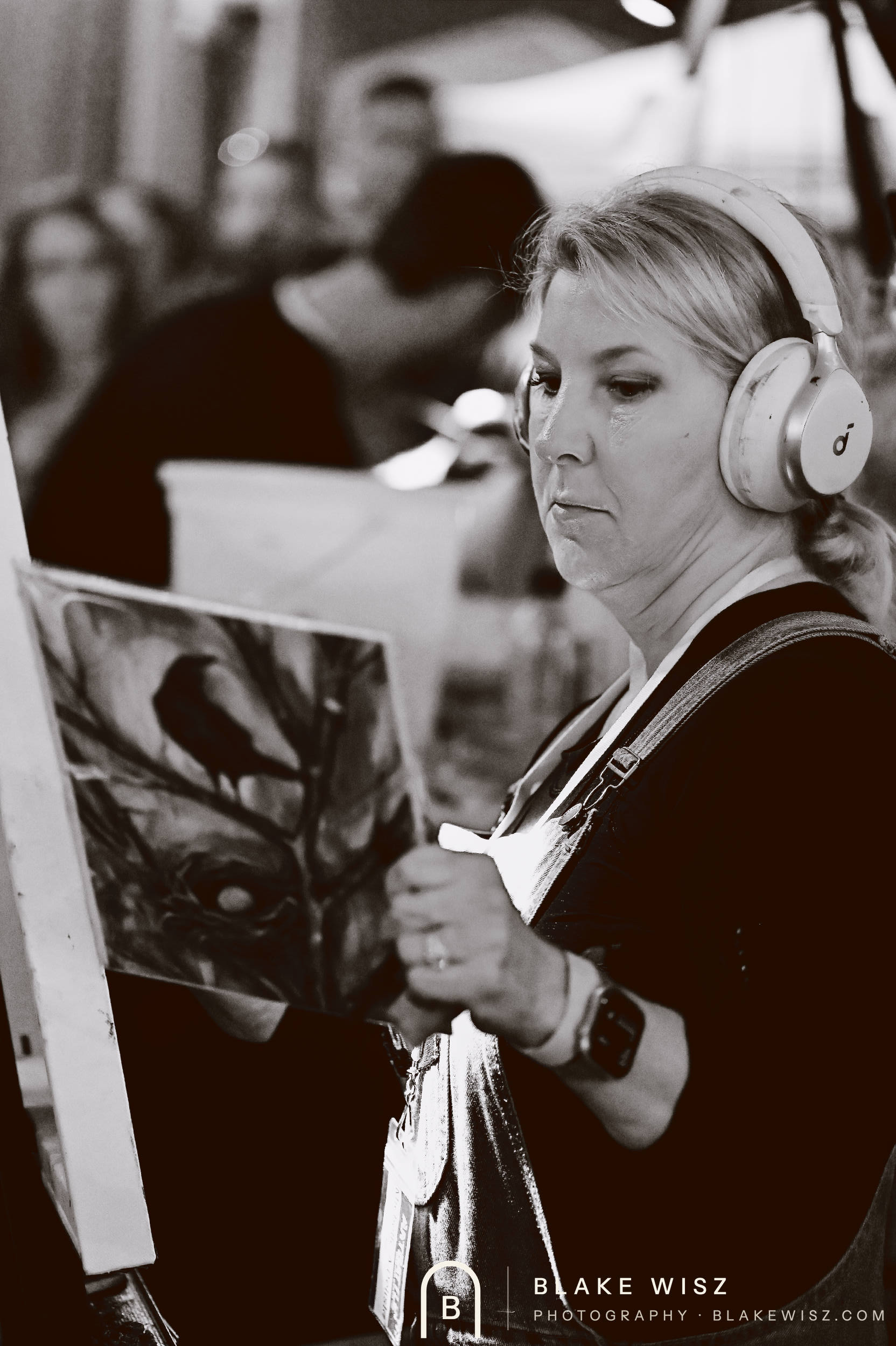 Black and white photo of Michelle A Delisle working from her printed bird reference