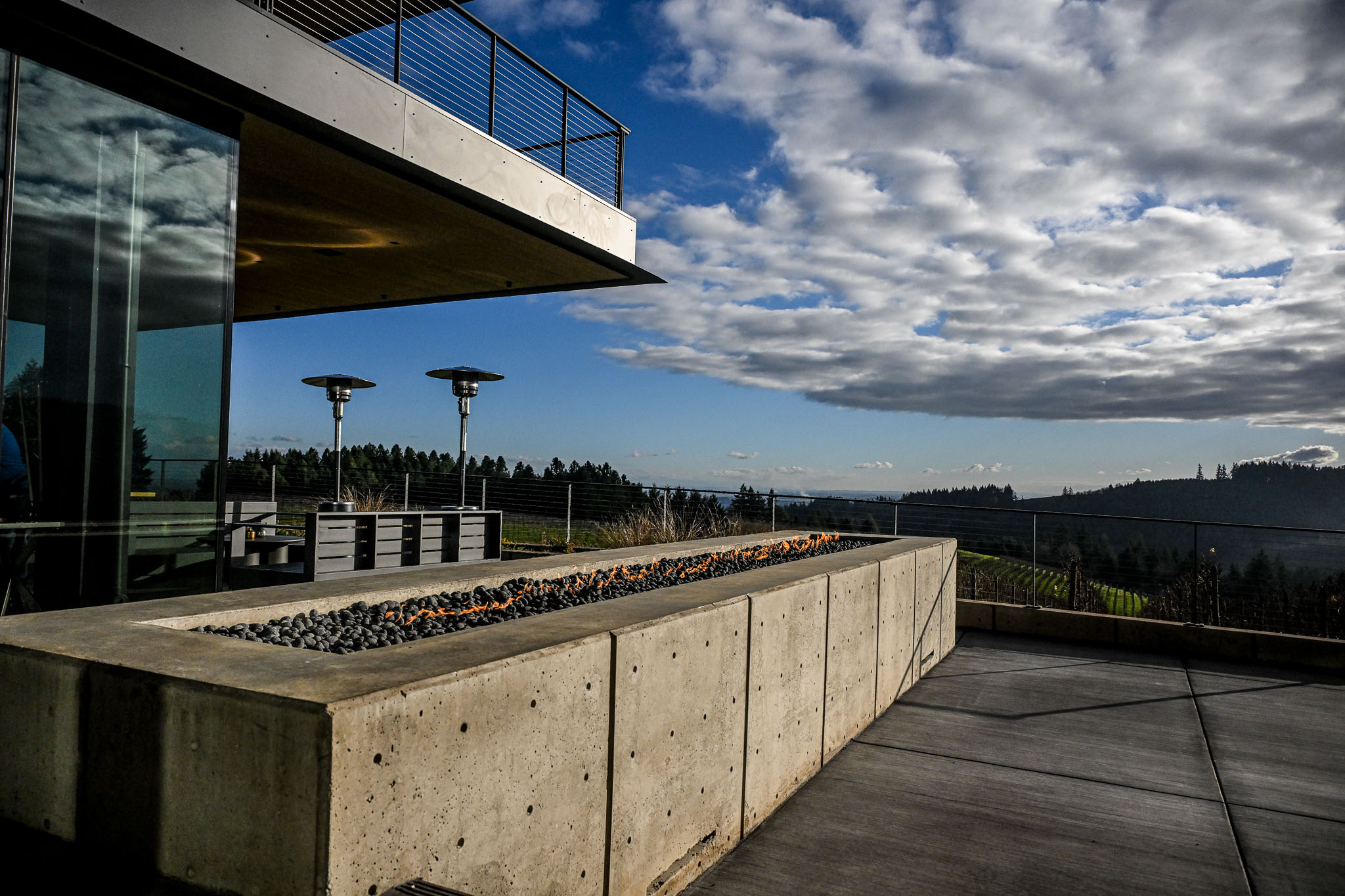 A lit fire trough on the LucidWild SkyTerrace overlooking the rolling Dundee Hills