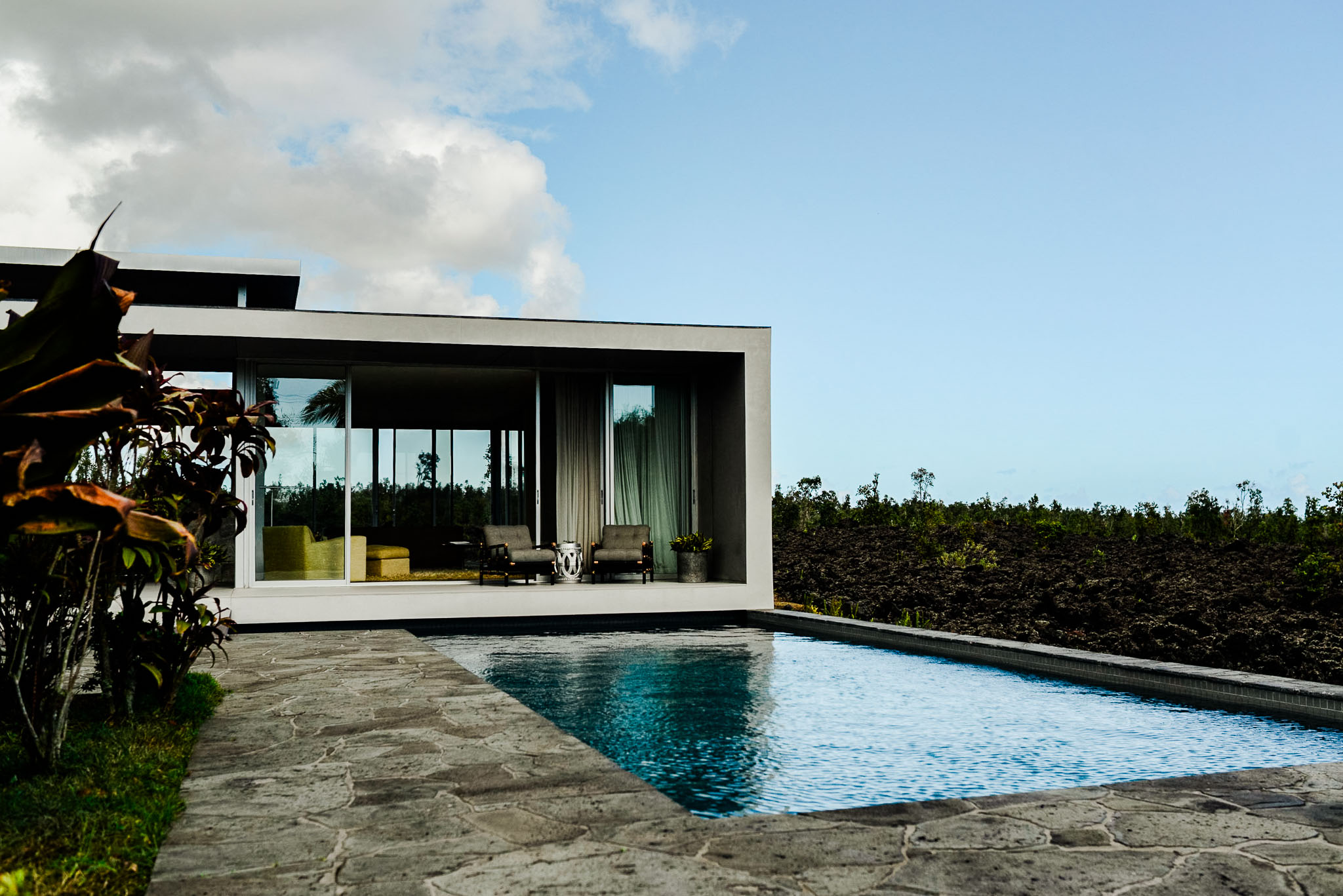 The house and pool at Lavaflow 1 with the lava flow running out behind