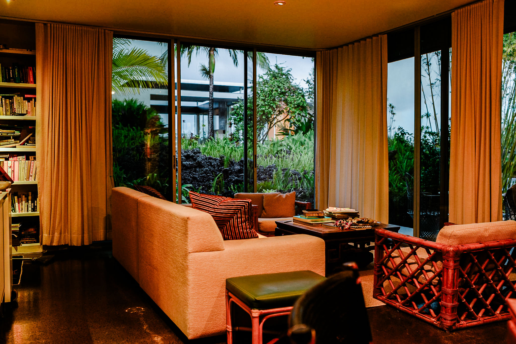 Orange sofa and curtains in the living room, glass opening to the lava field
