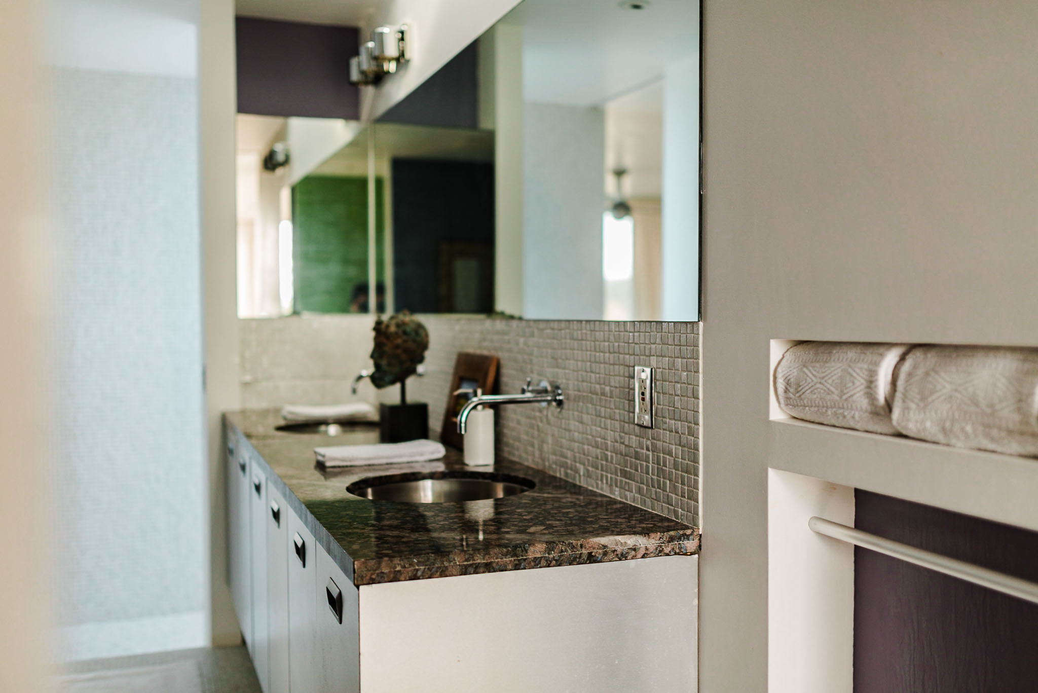 Bathroom vanity with a stone counter and a bench