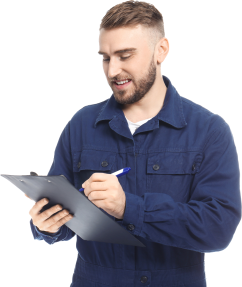 A mechanic in blue overalls holding a clipboard and smiling
