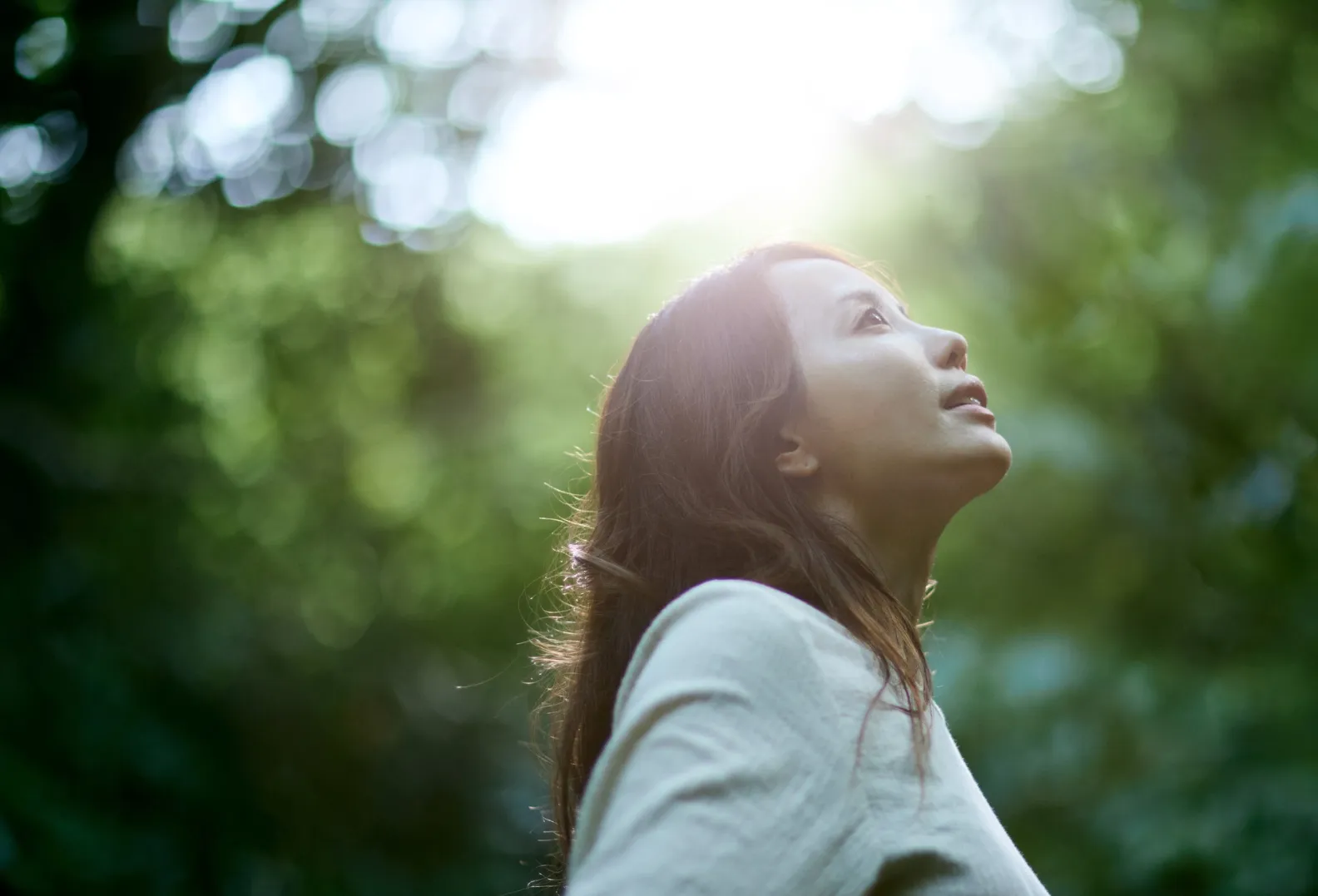Woman looking up at the light outdoors with the joy of using the best AI analytics tool to save time