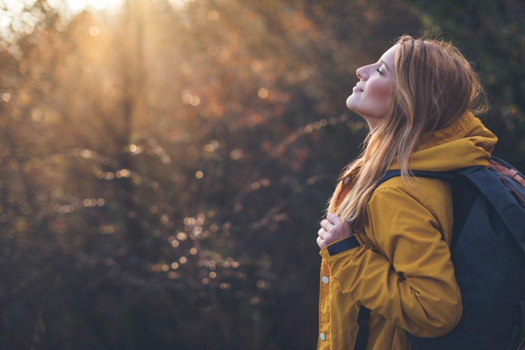 A woman with arms up in a sunset triumphant like a tool that makes social media ads for me