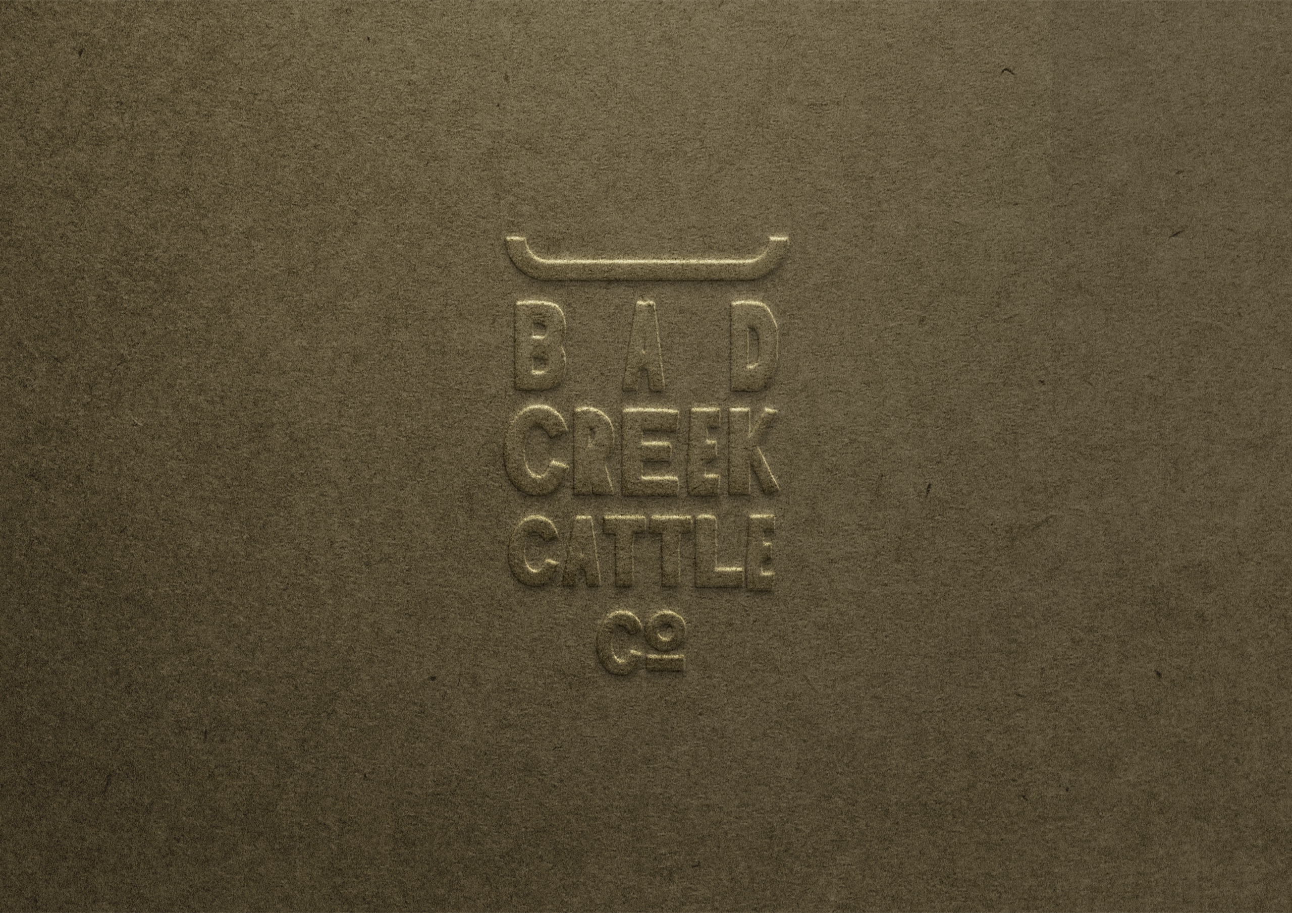 The Bad Creek brandmark embossed on paper stock