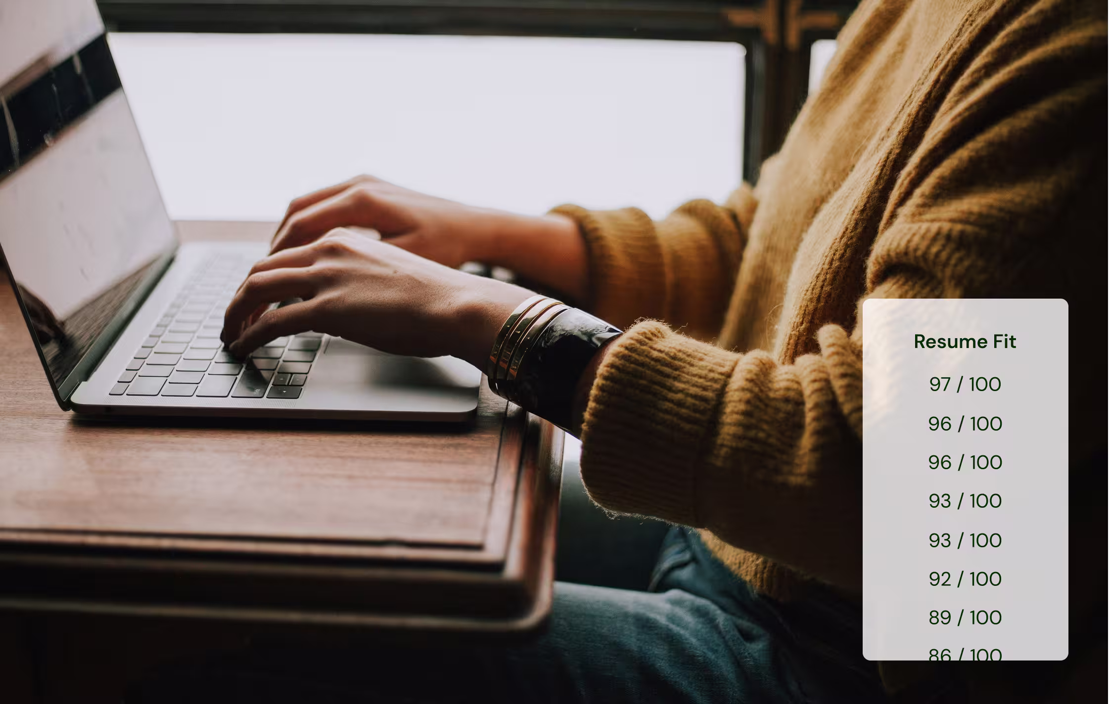 Person wearing a brown sweater typing on a laptop next to a list showing Resume Fit scores ranging from 84 to 97 out of 100.