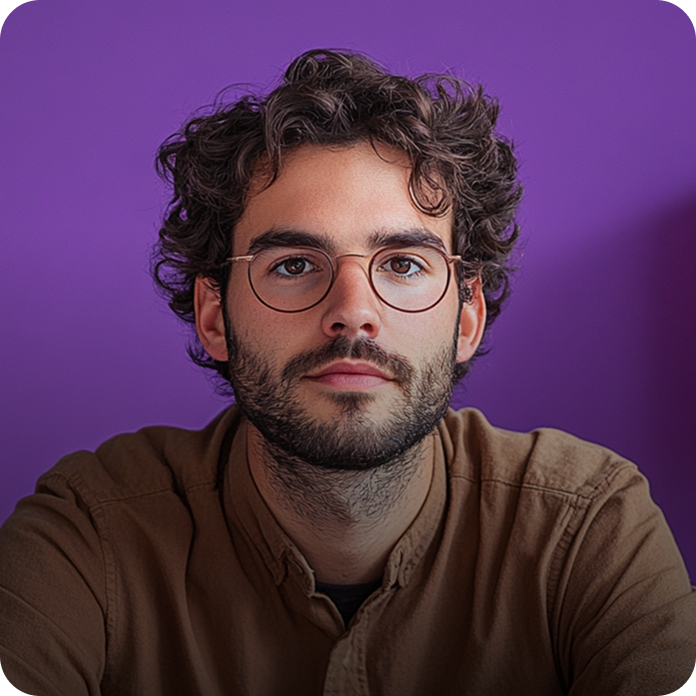 Curly-haired person with glasses against vibrant purple background