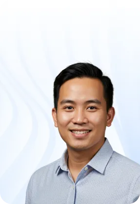 Smiling professional in light blue shirt against white background