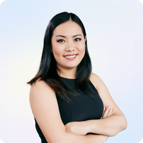 Smiling professional woman in black top with crossed arms