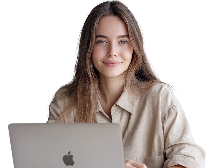 Young woman with long brown hair smiling while sitting behind an open Apple laptop.