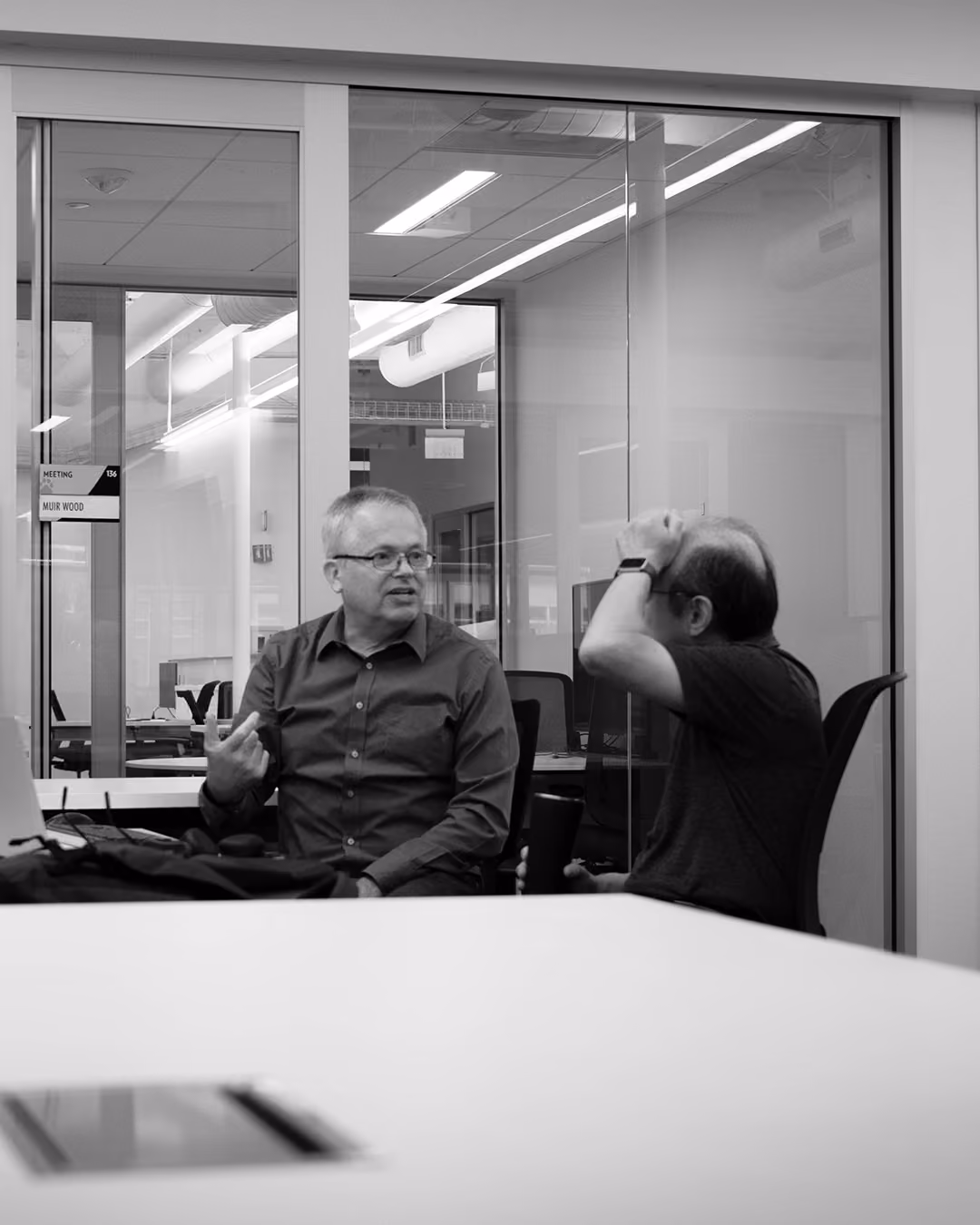 Two Tensordyne colleagues in conversation at the office