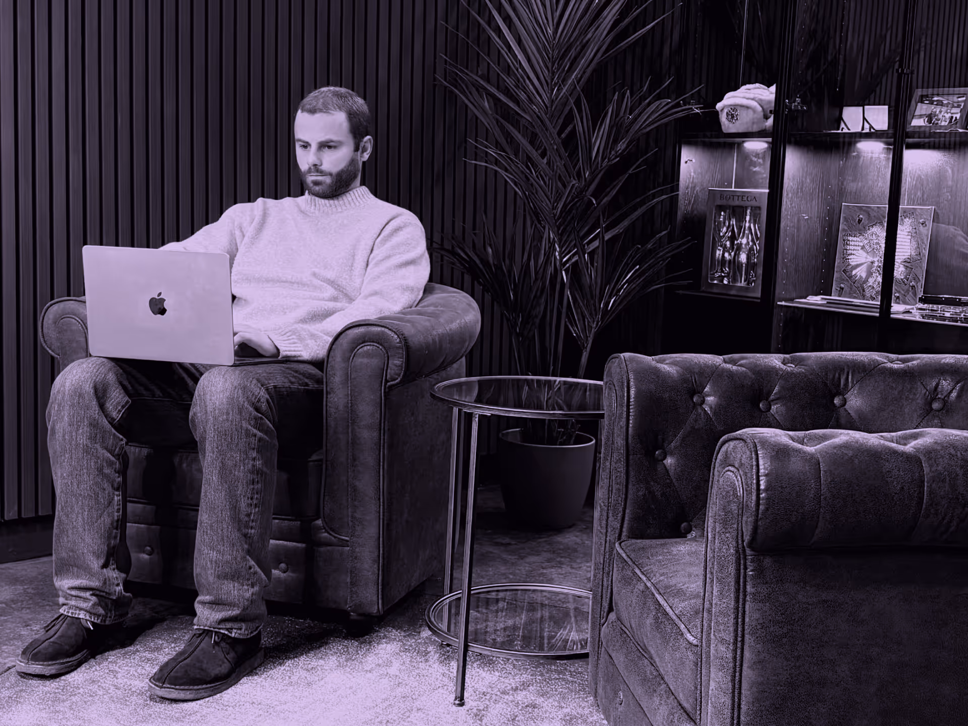 man sitting on chair with computer working on incident response retainer
