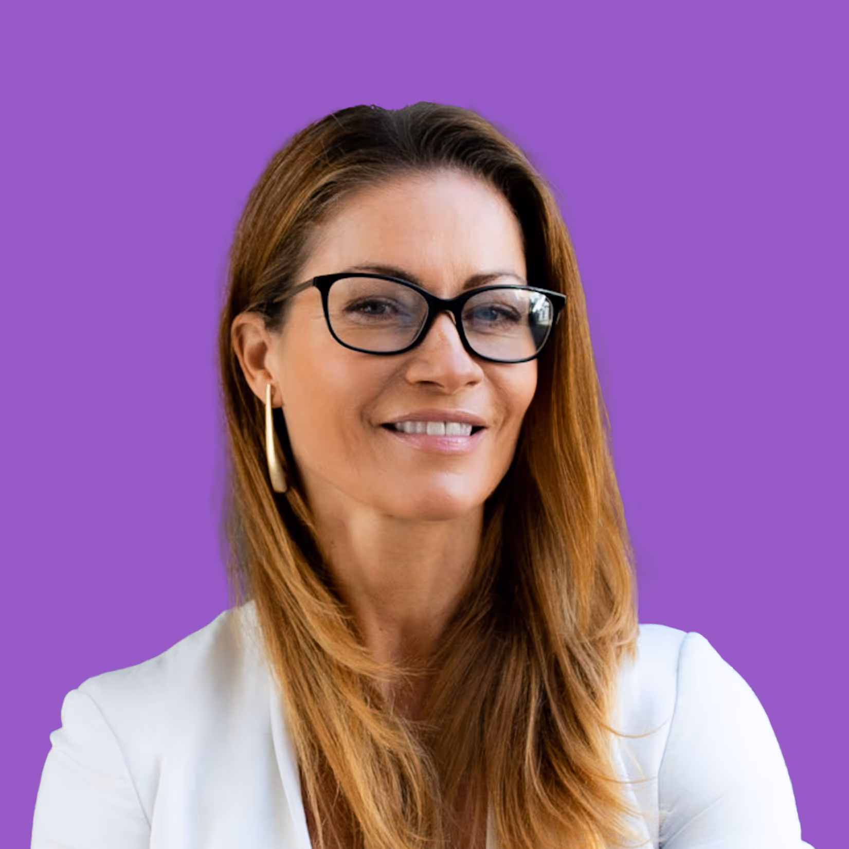 Smiling woman with long light brown hair wearing glasses, gold hoop earrings, and a white blazer against a purple background.
