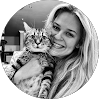 Woman smiling and holding a cat, featured on Red Team IT managed services Denton Texas team page