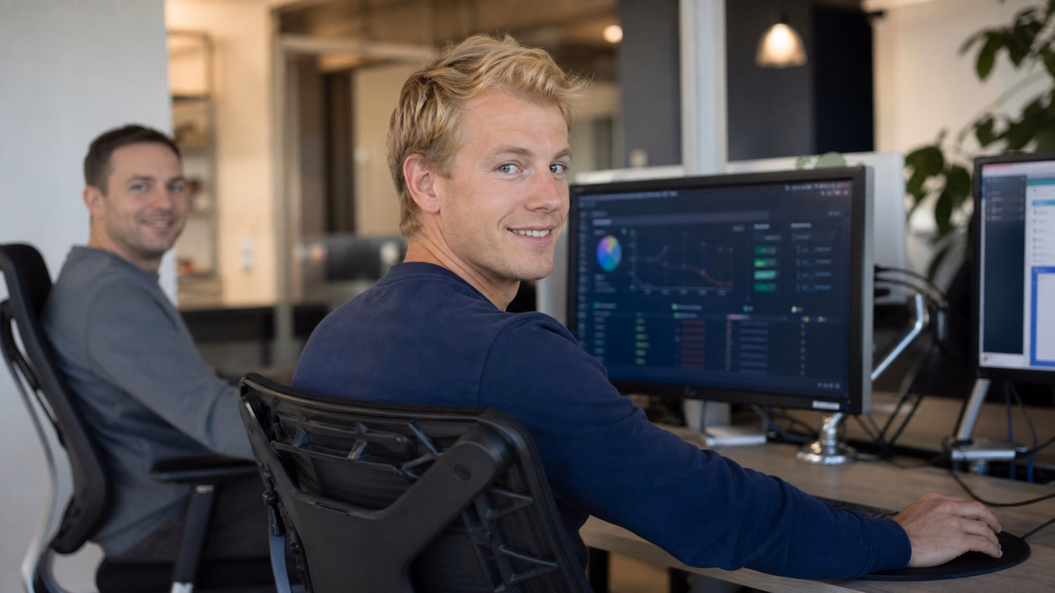 Blonde man at dark dashboard on monitor, swivel chair