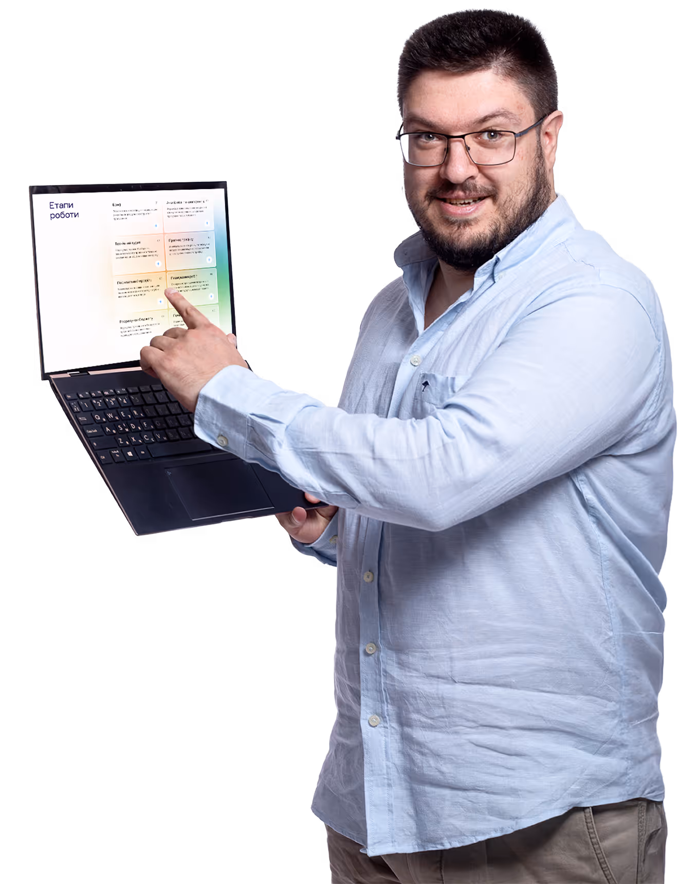 A man is holding a laptop computer and pointing at the screen.