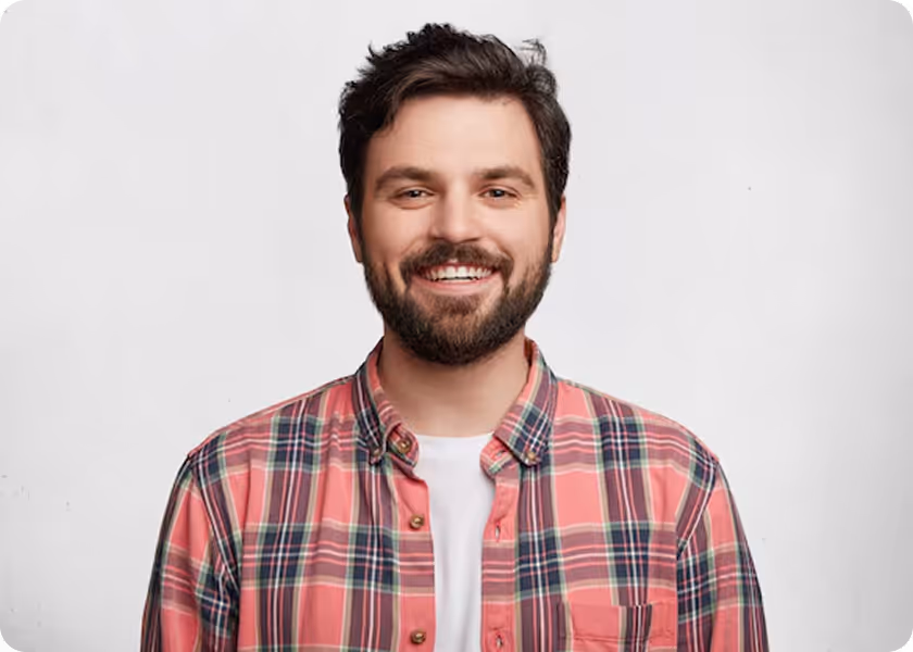 A man with a beard smiling at the camera.