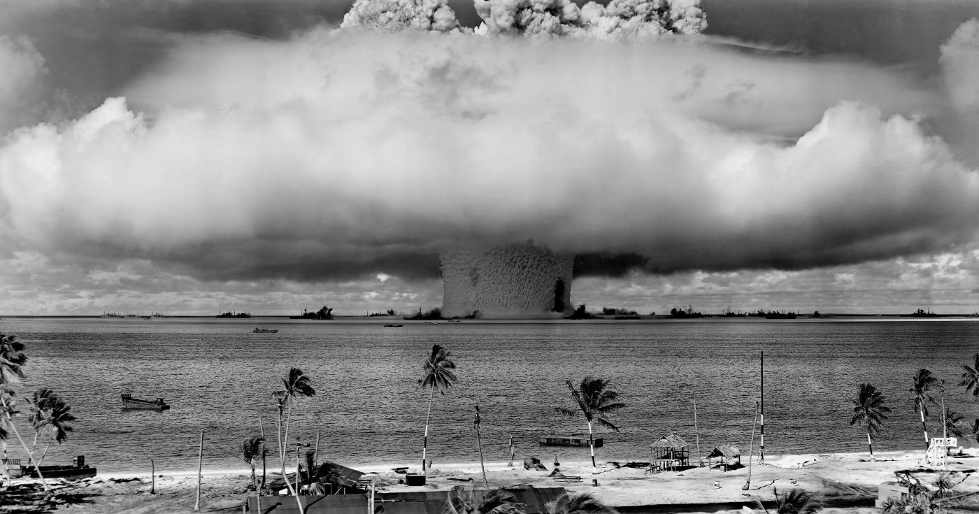 The massive mushroom cloud from an atomic bomb test explosion detonating over the lagoon at Bikini Atoll.