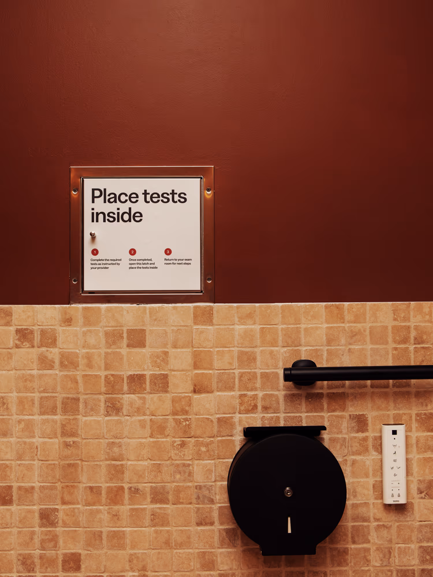 Wall sign reading 'Place tests inside' with instructions in a Haven bathroom.
