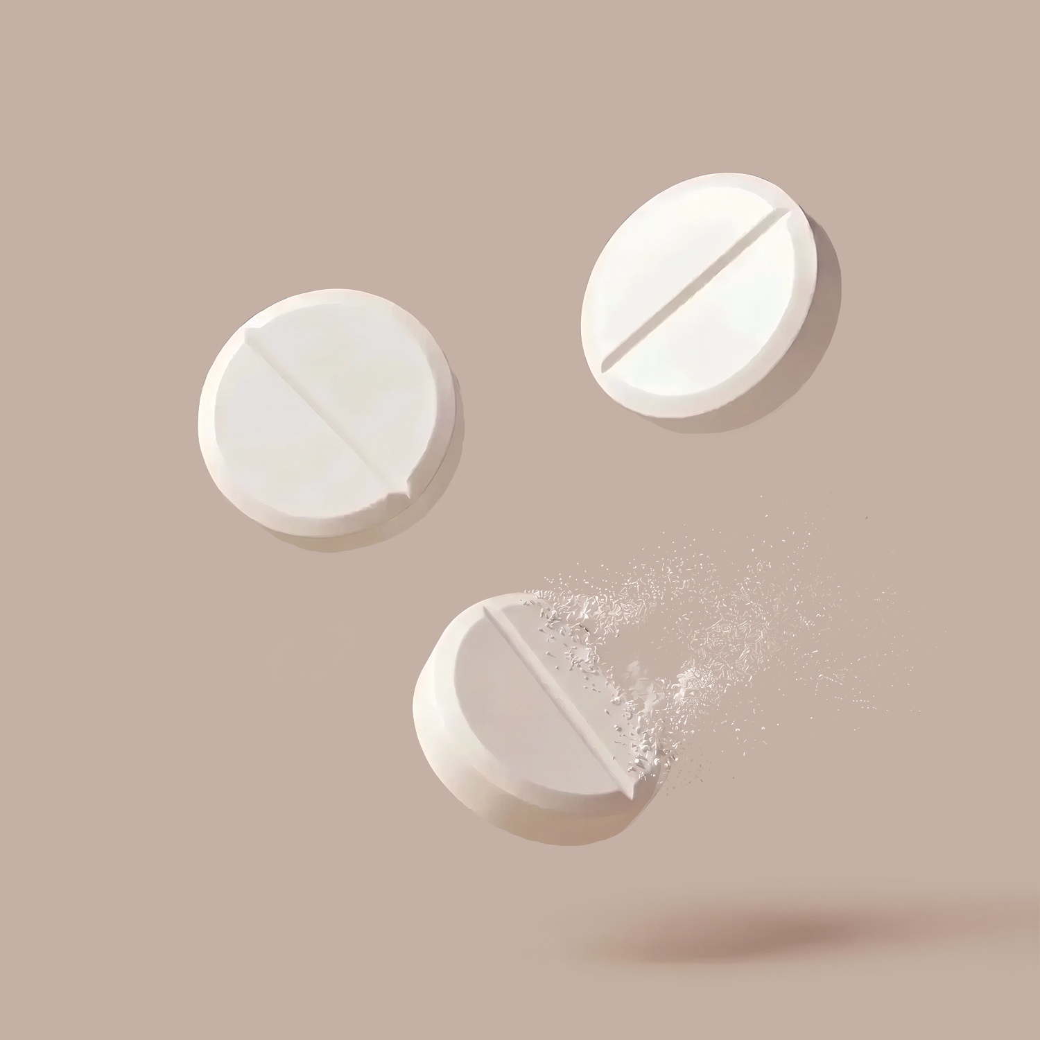 Three white round tablets on a beige background, one disintegrating into powder.