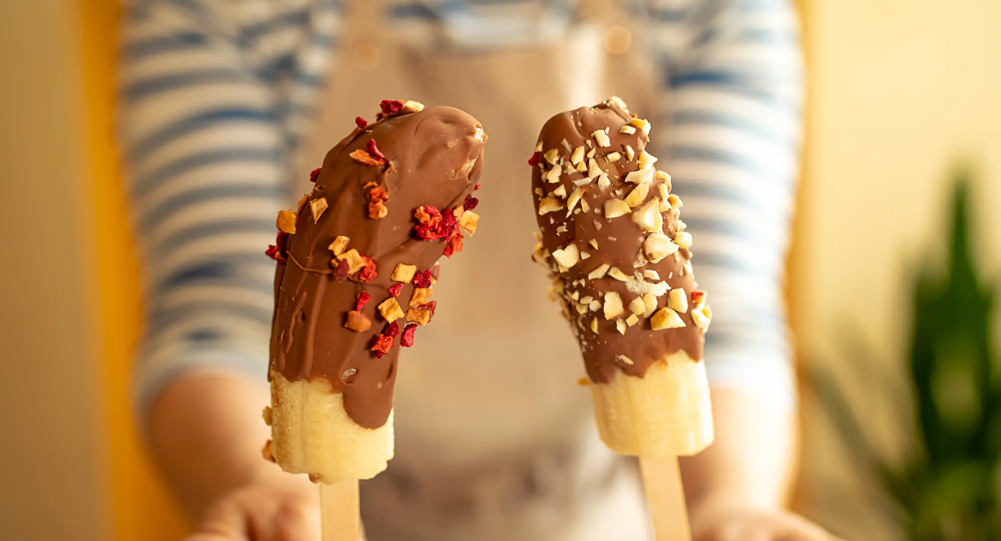 two banana chocolate popsicles