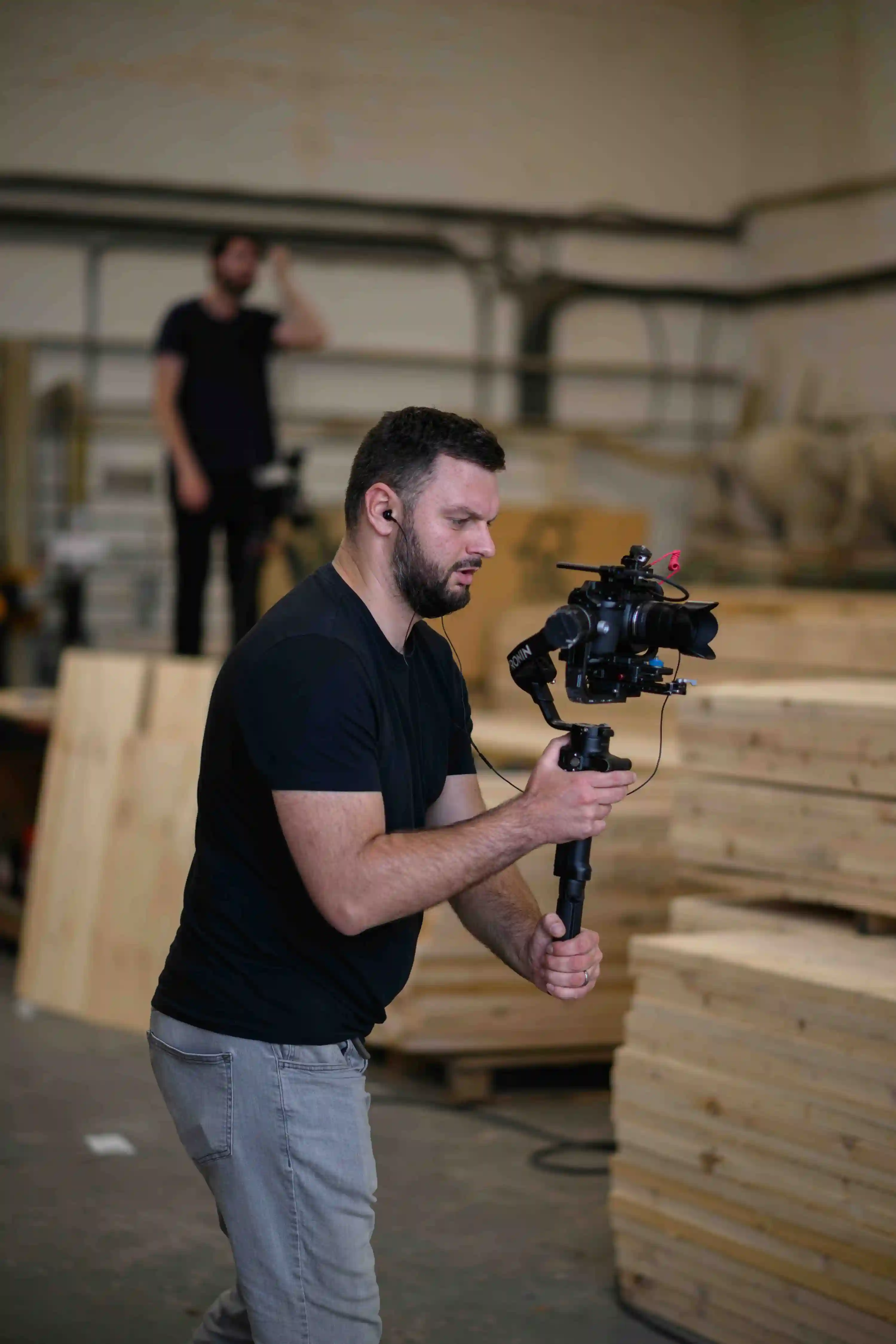 Videographer filming in warehouse for a client project.