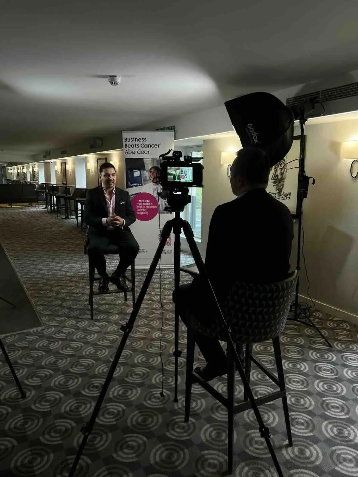 Filming an interview with a client.