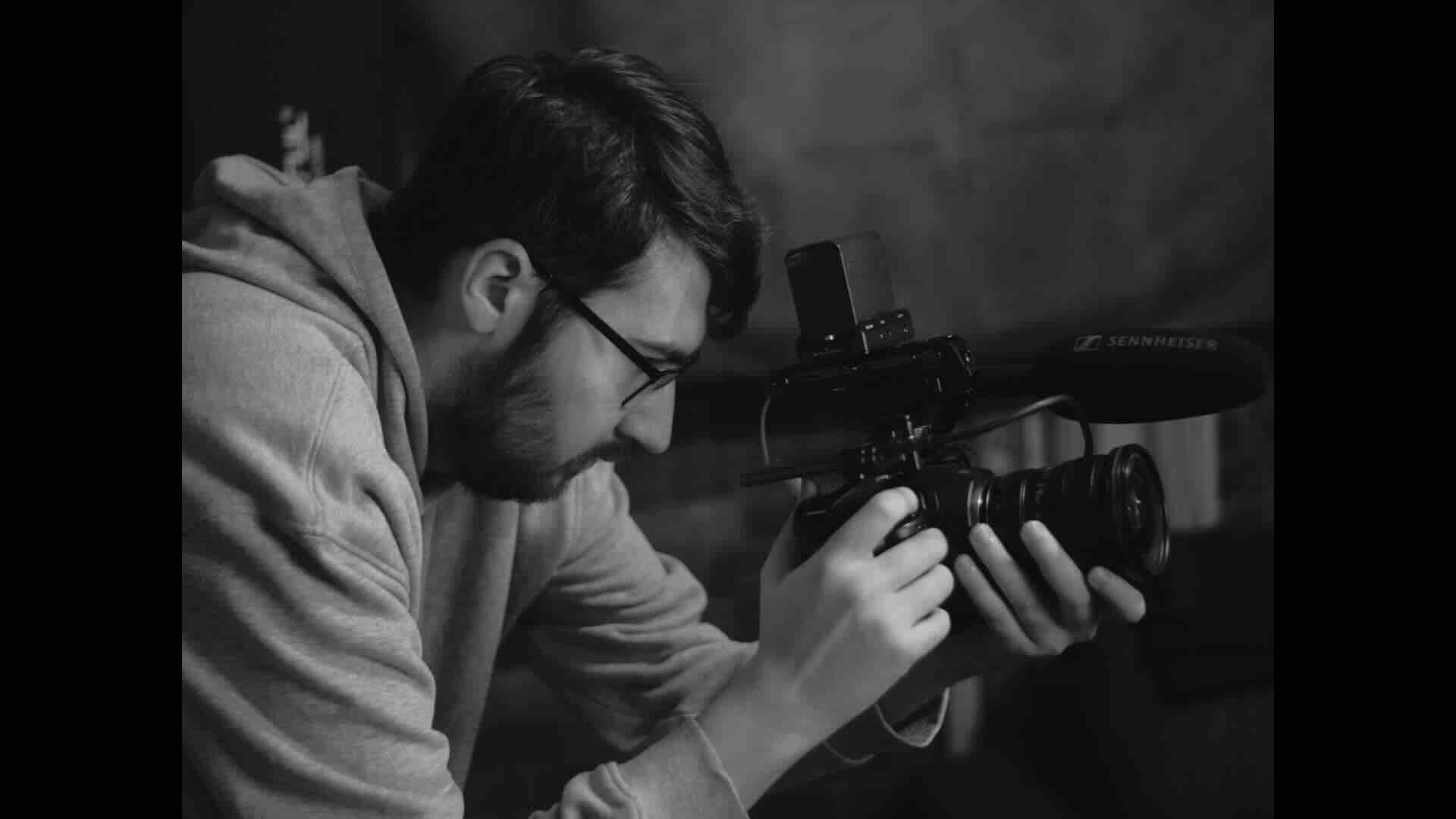 Behind-the-scenes videographer capturing business video content for a company website
